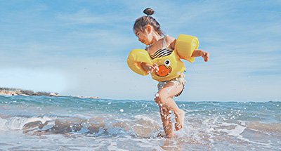 Child playing in surf